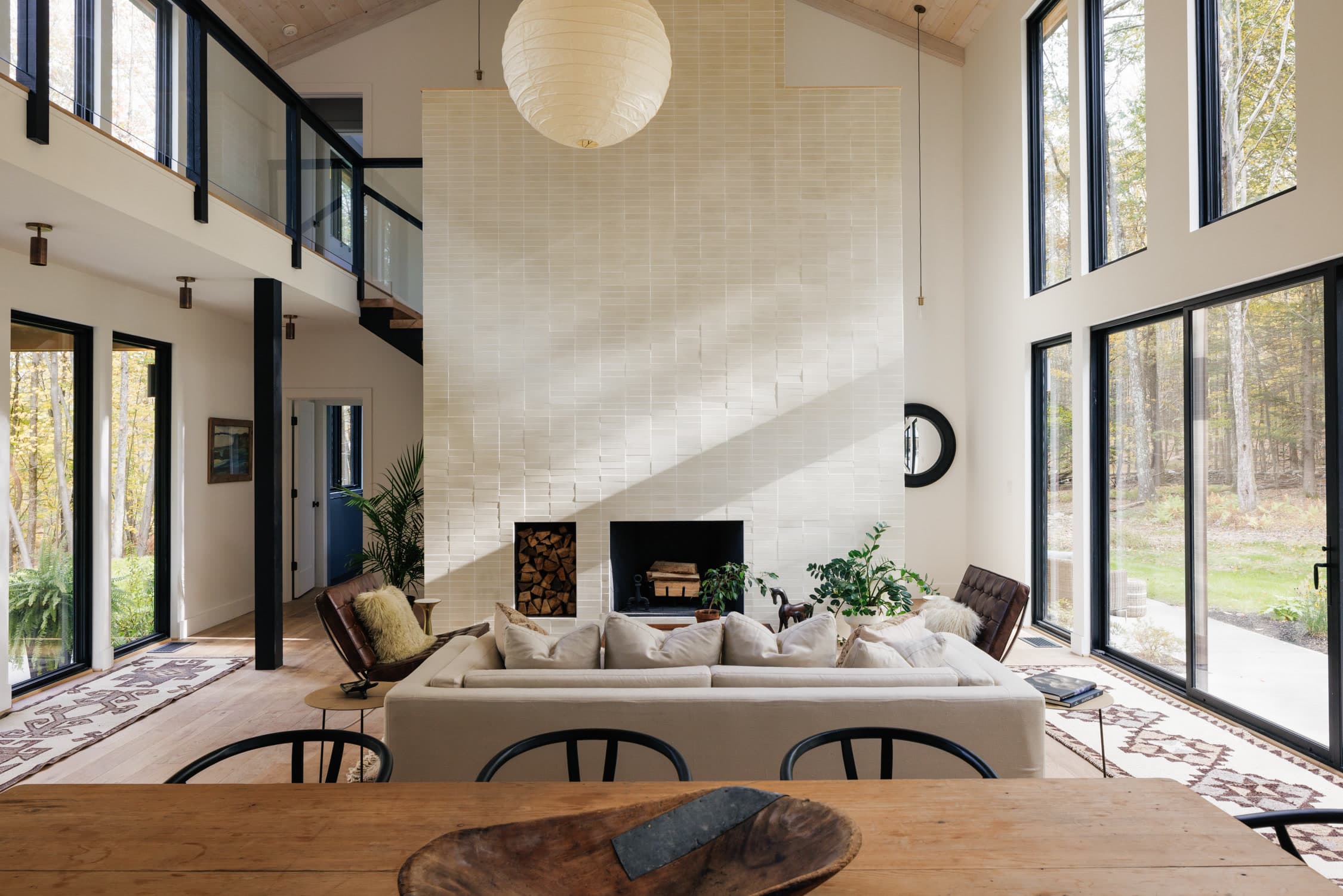 softly designed living room with a blue couch to the left, patterned pillows on top...etc